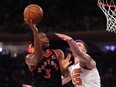 O.G. Anunoby of the Toronto Raptors shoots against Isaiah Hartenstein of the New York Knicks.