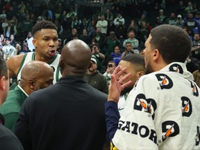 Giannis Antetokounmpo of the Milwaukee Bucks exchanges words with Tyrese Haliburton of the Indiana Pacers following a game.