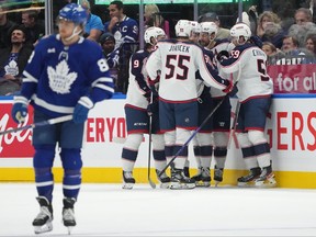 The Columbus Blue Jackets celebrate a goal as Toronto Maple Leafs winger William Nylander skates away.