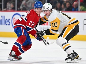 Canadiens' Cole Caufield battles with Penguins' Drew O'Connor during game Wednesday night at the Bell Centre. Caufield has has gone seven games without scoring a goal.