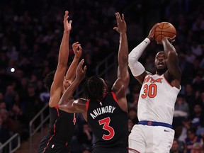 Julius Randle #30 of the New York Knicks shoots against O.G. Anunoby #3 of the Toronto Raptors during their game at Madison Square Garden on December 11, 2023 in New York City.