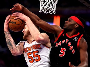 Isaiah Hartenstein (55) of the New York Knicks and Precious Achiuwa (5) of the Toronto Raptors battle for the ball during their game at Madison Square Garden on Monday, Dec. 11, 2023, in New York City.
