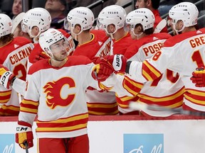 Andrew Mangiapane #88 of the Calgary Flames celebrates with his teammates after scoring against the Colorado Avalanche in the second period at Ball Arena on December 11, 2023 in Denver, Colorado.
