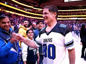 Dallas Mavericks owner Mark Cuban bumps fists with a fan after the game against the Los Angeles Lakers at American Airlines Center on December 12, 2023 in Dallas, Texas.