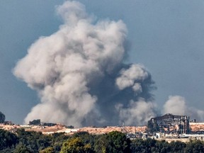 A smoke plume erupts during Israeli bombardment on the northern Gaza Strip near the border with southern Israel on December 17, 2023 amid continuing battles between Israel and the militant group Hamas.