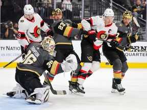 Logan Thompson #36, Alec Martinez #23 and Alex Pietrangelo #7 of the Vegas Golden Knights defend the net as Drake Batherson #19 and Brady Tkachuk #7 of the Ottawa Senators watch a teammate's shot on goal in the third period of their game at T-Mobile Arena on December 17, 2023 in Las Vegas, Nevada.