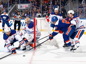 The Edmonton Oilers defend against Anders Lee #27 of the New York Islanders during the second period at UBS Arena on December 19, 2023 in Elmont, New York.