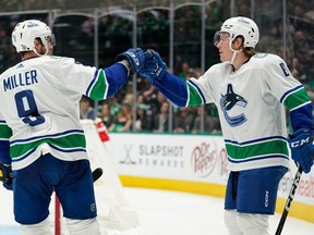 Brock Boeser gets a congrats from Conor Garland after scoring his 24th goal of the season against the Dallas Stars.