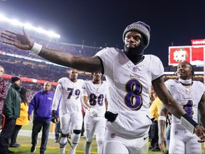 Lamar Jackson (8) of the Baltimore Ravens high-fives a fan while heading into the locker-room after the first half against the San Francisco 49ers at Levi's Stadium on Monday, Dec. 25, 2023 in Santa Clara, Calif.