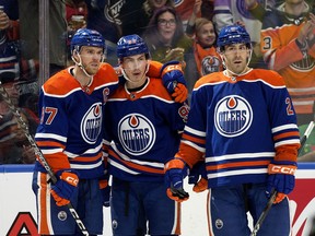Edmonton Oilers Connor McDavid (97), Ryan Nugent-Hopkins (93) and Evan Bouchard (2) celebrate a goal against the Chicago Blackhawks at Rogers Place, in Edmonton on Dec. 12, 2023.