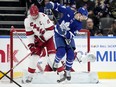 Maple Leafs centre Auston Matthews (right) tries to screen Hurricanes goaltender Pyotr Kochetkov as teammate Jordan Staal (left) defends during third period NHL action in Toronto, Saturday, Dec. 30, 2023.