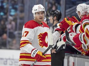 Calgary Flames forward Yegor Sharangovich (17) is congratulated for his goal against the Seattle Kraken during the third period of an NHL game on Saturday, Nov. 4, 2023, in Seattle.