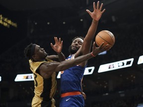 Raptors forward Pascal Siakam attempts an underhand layup against New York Knicks centre Mitchell Robinson at Scotiabank Arena in Toronto, Friday, Dec. 1, 2023.