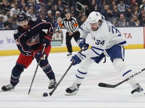 Maples Leafs' Auston Matthews carries the puck across the blue line as Columbus Blue Jackets' Kirill Marchenko defends during the first period on Saturday, Dec. 23, 2023, in Columbus, Ohio.
