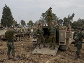 Israeli soldiers are seen at a staging area near the Israeli-Gaza border, in southern Israel, Thursday, Dec. 28, 2023. The army is battling Palestinian militants across Gaza in the war ignited by Hamas' Oct. 7 attack into Israel.