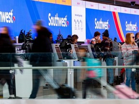 Travellers walk past the Southwest Airlines check-in counter at Denver International Airport on December 28, 2022 in Denver, Colorado.