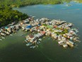 Traditional fishing village in Asia with fishing boats and houses standing in the sea. Philippines, Mindanao.