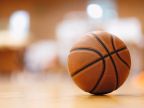 Close-up image of basketball ball over floor in the gym.