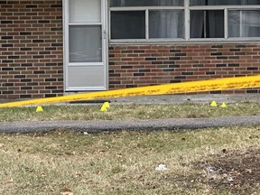 Toronto Police tape and markers at the scene on Monday, Dec. 11, 2023, the day after a woman fell from a balcony at 5 Glamorgan Ave. in Toronto.
