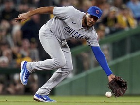 Chicago Cubs third baseman Jeimer Candelario reaches for a grounder during a game in Pittsburgh, Saturday, Aug. 26, 2023.