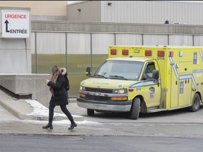 An ambulance pulls out of the emergency entrance of a hospital in Montreal, Wednesday, Dec. 29, 2021.
