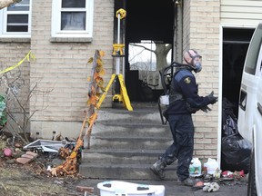 Ontario Fire Marshal officials at the scene of a blaze that killed two adults and two children in a Hamilton townhouse on Thursday, Dec. 29, 2022.