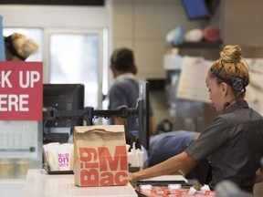 An employee packs an order for a customer at a McDonald's restaurant in Phoenix, Ariz.