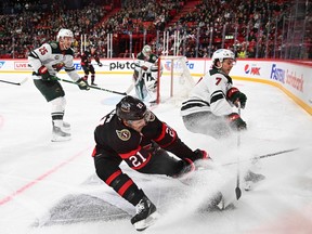 Defender Brock Faber of Minnesota Wild (R) and forward Mathieu Joseph of Ottawa Senators vie for the puck during the NHL Global Series Ice Hockey match between Ottawa Senators and Minnesota Wild in Stockholm on November 18, 2023.