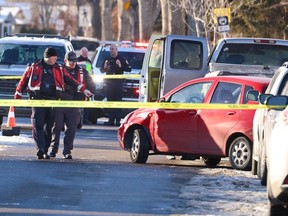 Calgary police contain the scene where one person was killed in front of a home in the 6900 block of Temple Drive N.E. on Tuesday, December 12, 2023.