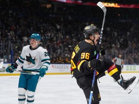 Vancouver Canucks' Andrei Kuzmenko celebrates his first goal as San Jose Sharks' Fabian Zetterlund  looks on during the first period of an NHL  game in Vancouver, on Saturday, December 23, 2023.