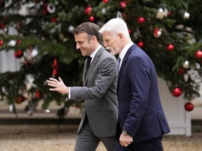 French President Emmanuel Macron, left, welcomes Czech Republic's President Petr Pavel before their talks Wednesday, Dec. 20, 2023 at the Elysee Palace in Paris.