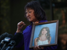 Carol Todd holds a photo of her late teenage daughter Amanda Todd, who died by suicide in 2012.