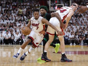 Kyle Lowry (7) of the Miami Heat drives past a screen set by Cody Zeller (44) against Marcus Smart (36) of the Boston Celtics during Game 3 of the Eastern Conference Finals at Kaseya Center on Sunday, May 21, 2023, in Miami.