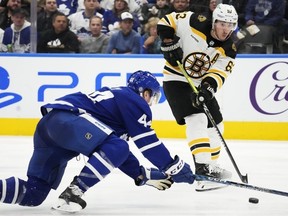 Boston Bruins' Brad Marchand passes past Toronto Maple Leafs' Morgan Rielly during third period NHL hockey action in Toronto on Wednesday, February 1, 2023.