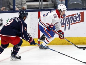 The Canadiens say Alex Newhook will be out for 10 to 12 weeks with a high ankle sprain. Newhook, right, controls the puck in front of Columbus Blue Jackets defenceman Zach Werenski in Columbus, Ohio, on Nov. 29, 2023.