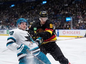 Nikita Zadorov has been a Vancouver Canuck for nearly a month and says the adjustment has been smooth. Zadorov, right, checks San Jose Sharks' William Eklund during the third period on Dec. 23, 2023.