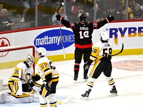 Ottawa Senators centre Tim Stutzle (18) celebrates after scoring on Pittsburgh Penguins goaltender Alex Nedeljkovic (39) to win the game in overtime NHL hockey action in Ottawa, on Saturday, Dec. 23, 2023.