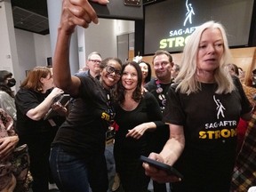 SAG-AFTRA President Fran Drescher, takes a selfie with a member of the TV/Theatrical Negotiating Committee in celebration after a news conference at the SAG-AFTRA offices in Los Angeles on Friday, Nov. 10, 2023.
