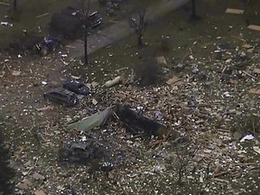 This image from video shows the remains of a house scattered after an explosion in Northfield Township, Mich., on Saturday Dec. 30, 2023. Several were killed and injured.
