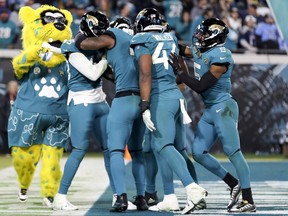 Josh Allen #41 of the Jacksonville Jaguars celebrates with teammates after his fumble return for a go ahead touchdown during the fourth quarter against the Tennessee Titans at TIAA Bank Field on Jan. 7, 2023 in Jacksonville, Fla.