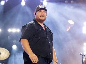 Luke Combs performs during CMA Fest 2022, June 11, 2022, in Nashville, Tenn. Combs is making amends to a disabled Florida woman who sells tumblers online after she was ordered to pay him $250,000 when she got snared in a crackdown his lawyers launched against companies that sell unauthorized merchandise with his image or name on it. In an Instagram video posted Wednesday, Dec. 13, 2023, Combs said he told his attorneys to remove Nicol Harness from a lawsuit they filed in an Illinois federal court and that he was sending her $11,000.