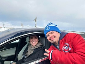 Jeremy Mylo poses with Canadiens' Samuel Montembeault outside the CN Sports Complex in Brossard after giving the goalie a Christmas card.