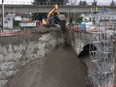 Dirt is poured into an open pit foundation for a high-rise building under construction Friday to shore-up the walls after a cavern opened-up on the Northside of the foundation pouring tonnes of soil and rocks into the pit Thursday. (Photo by Jason Payne/ PNG)