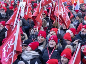 Striking teachers and their supporters hold a rally in front of Premier Francois Legault's office, Friday, Dec. 22, 2023, in Montreal.