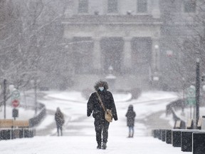 A person walks through the McGill University campus during light snowfall in Montreal on Sunday, Dec. 20, 2020.