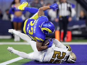 Kyren Williams of the Los Angeles Rams scores against Paulson Adebo of the New Orleans Saints at SoFi Stadium on December 21, 2023 in Inglewood, California.
