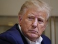 FILE - Former President Donald Trump listens as he speaks with reporters while in flight on his plane after a campaign rally at Waco Regional Airport, in Waco, Texas, March 25, 2023, while en route to West Palm Beach, Fla. The Supreme Court said Friday, Dec. 22, that it will not immediately take up a plea by special counsel Jack Smith to rule on whether former President Donald Trump can be prosecuted for his actions to overturn the 2020 election results.