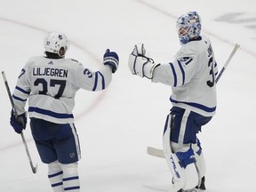 Toronto Maple Leafs goaltender Martin Jones celebrates with defenceman Timothy Liljegren after defeating the San Jose Sharks.