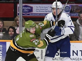 Bronson Ride of the North Bay Battalion, left, jousts with Finn Harding of the visiting Mississauga Steelheads in their OHL game on Jan. 11, 2024, in North Bay, Ont.