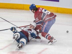 Canadiens' Michael Pezzetta dumps Avalanche defenceman Josh Manson on his backside after a check Monday night at the Bell Centre.